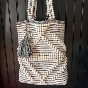 Black and white woven bag with tassel